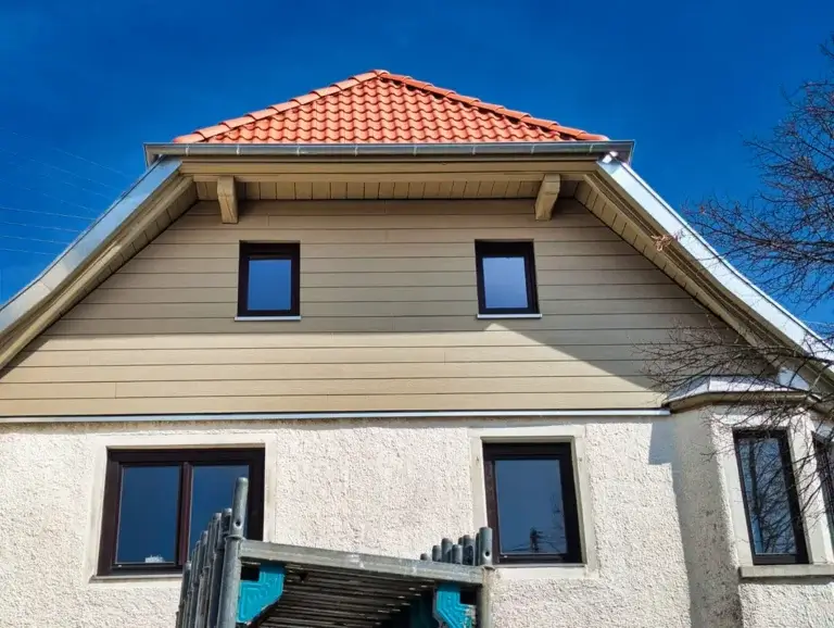 Wohnhaus nach der Fassadensanierung mit heller horizontaler Fassadenverkleidung